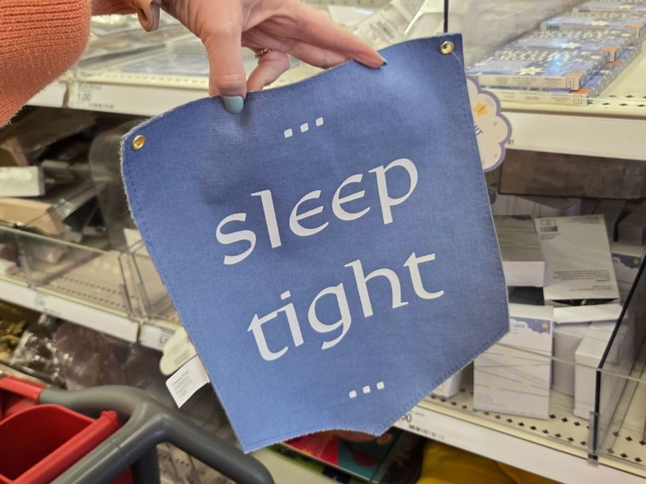 Sleep Tight Little Knight pennant in hand in store