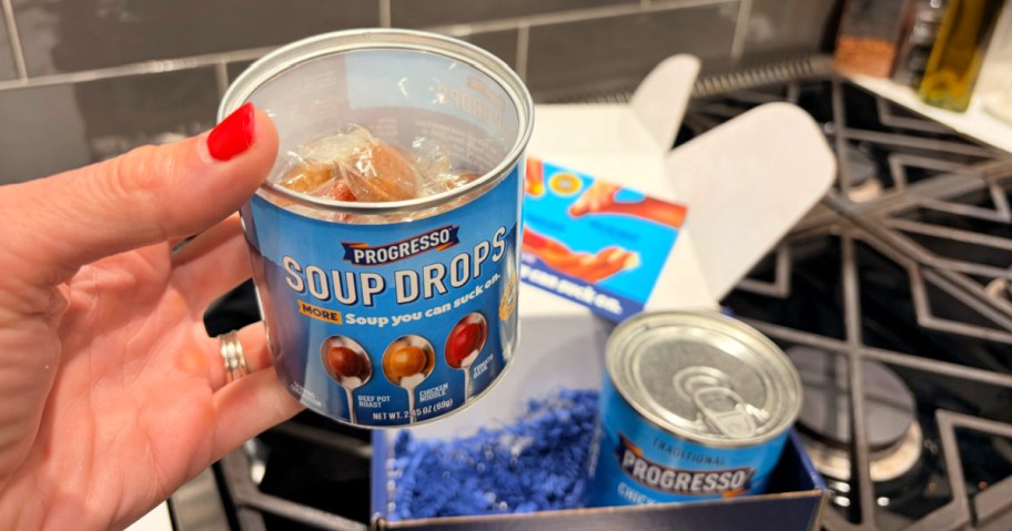Person holding up container of Progresso soup drops