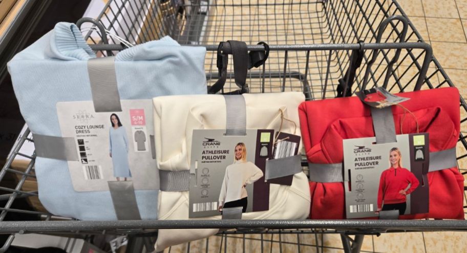 Three different pullover sweaters inside of shopping cart