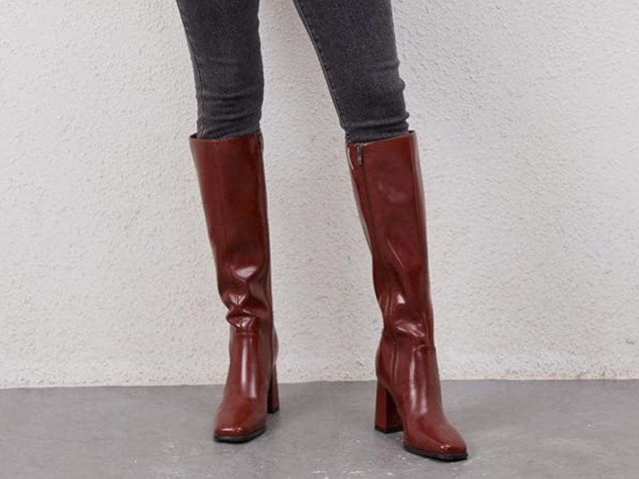 A woman wearing jeans and brown boots