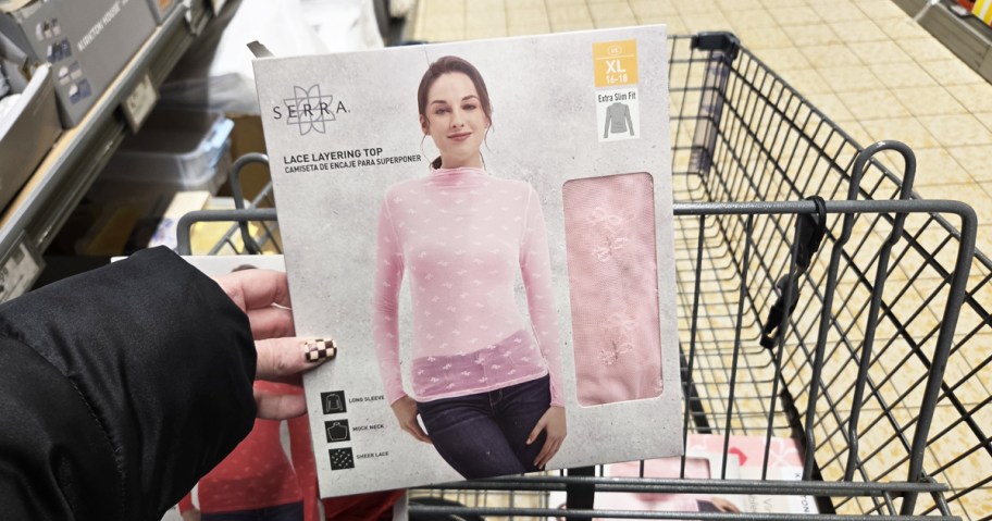 hand holding up a pink lace layering top 