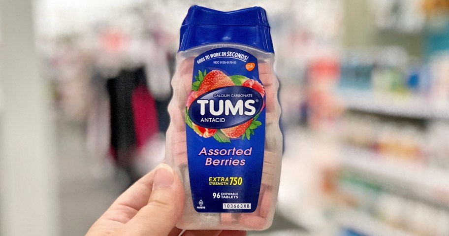 hand holding bottle of TUMS antacids in store