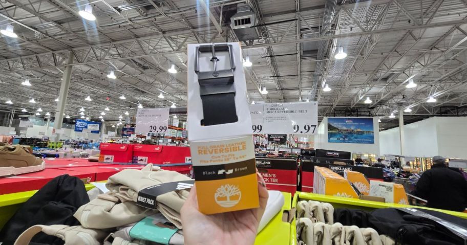 a person holding up a Timberland belt