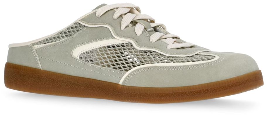 one green sneaker with lace accents