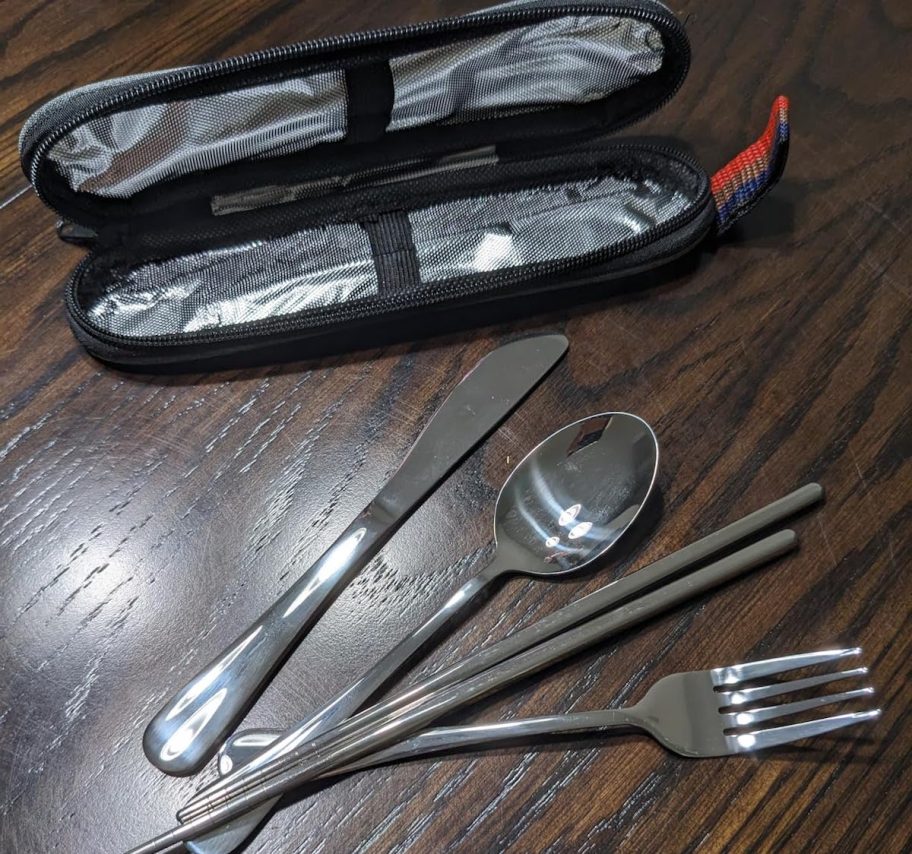 Utensils with travel case sitting on wood table