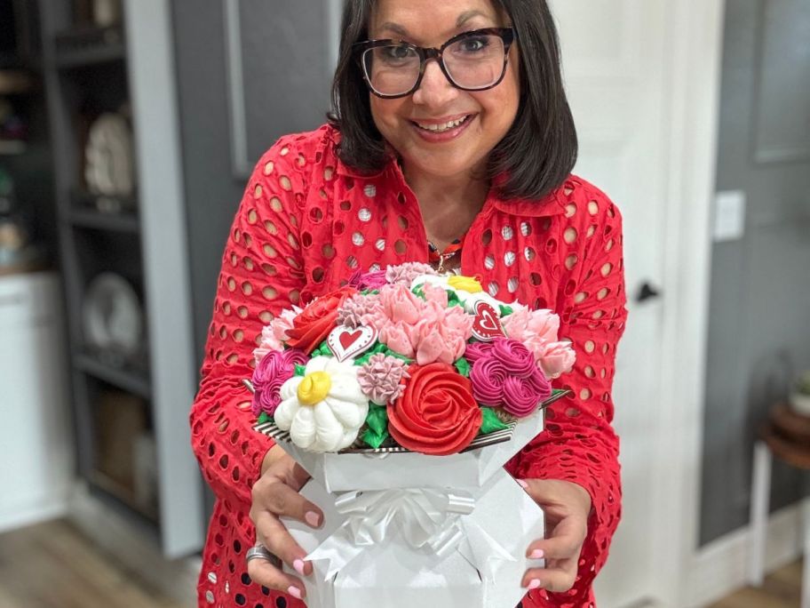 Woman holding a walmart valentine's day cupcake bouquet