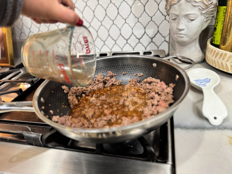 adding sauce to ground beef