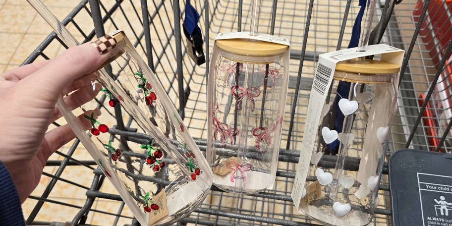 hand holding glass tumbler and more tumblers in cart