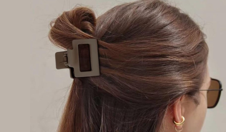 woman with brown hair and small hair clip