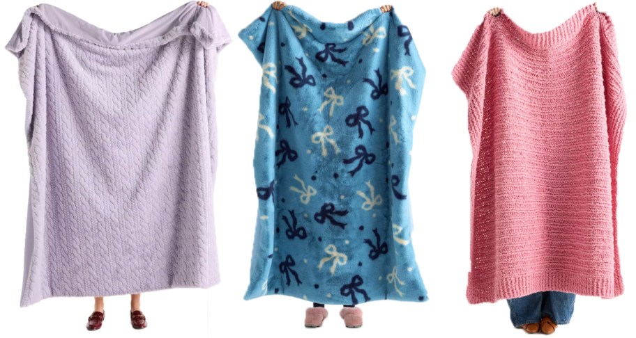 people holding up purple, blue and pink throw blankets 