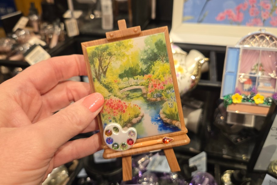 hand holding mini easel wall plug