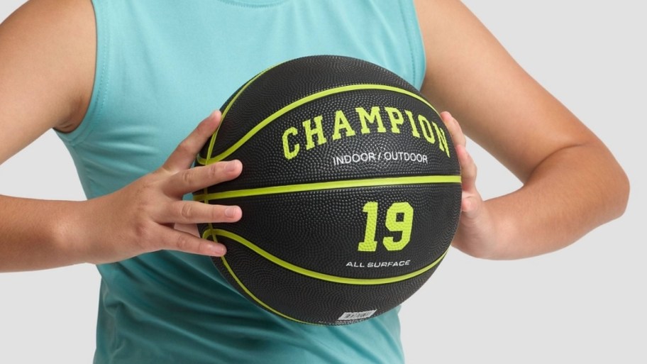 girl holding basketball with two hands