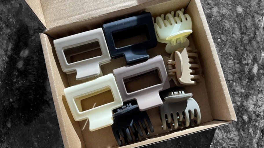 8 count pack of small claw clips in assorted colors on a small cardboard box