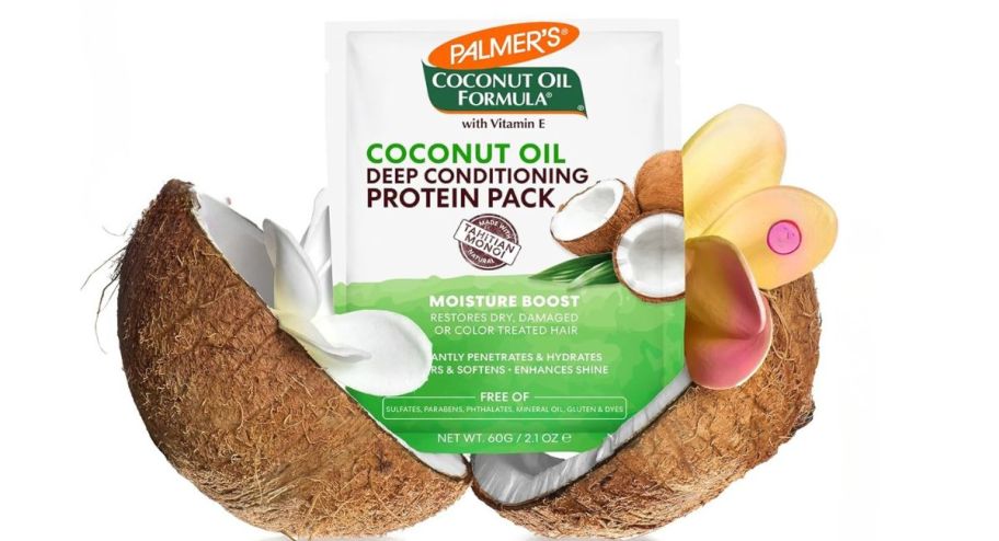 palmers coconut hair treatment sticking out of a sliced coconut