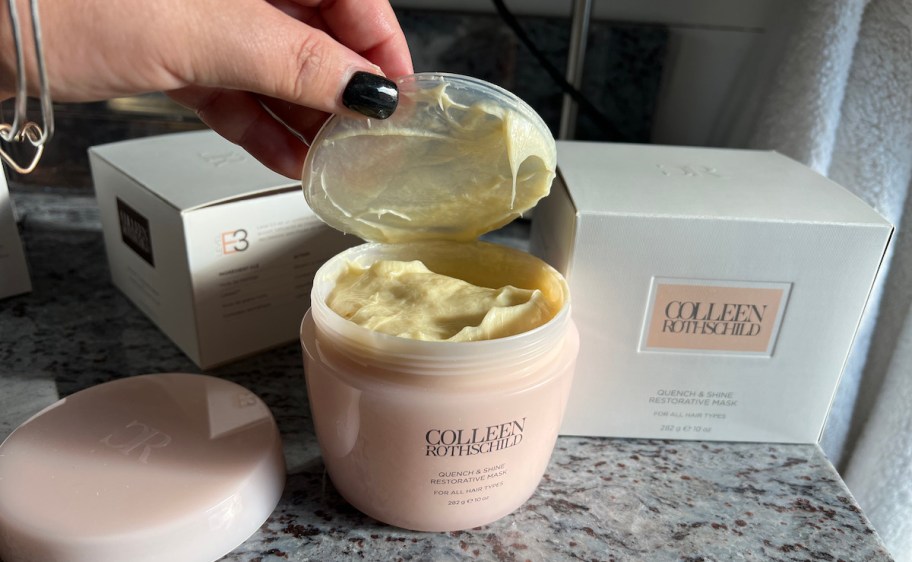 hand holding open lid to colleen rothschild face mask