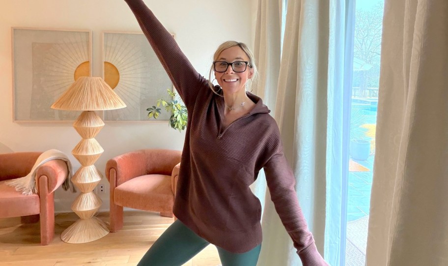 woman posing in burgundy colored pullover sweater