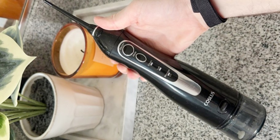 hand holding black waterpik