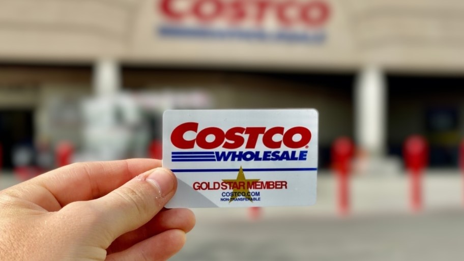 a mans hand holding a costco gold star membership