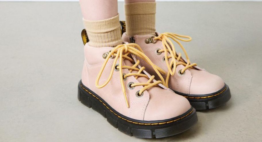 dr marten in pink displayed on a woman