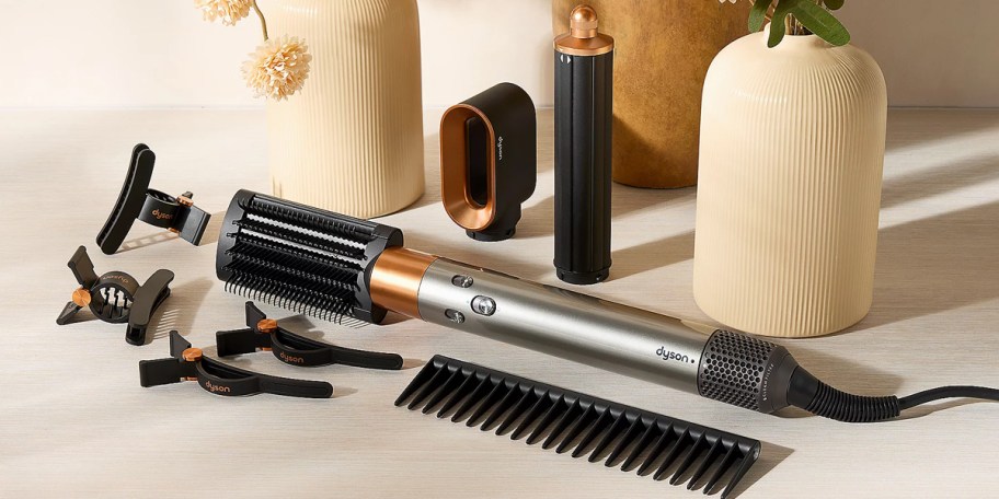 silver and black dyson airwrap with accessories on counter 