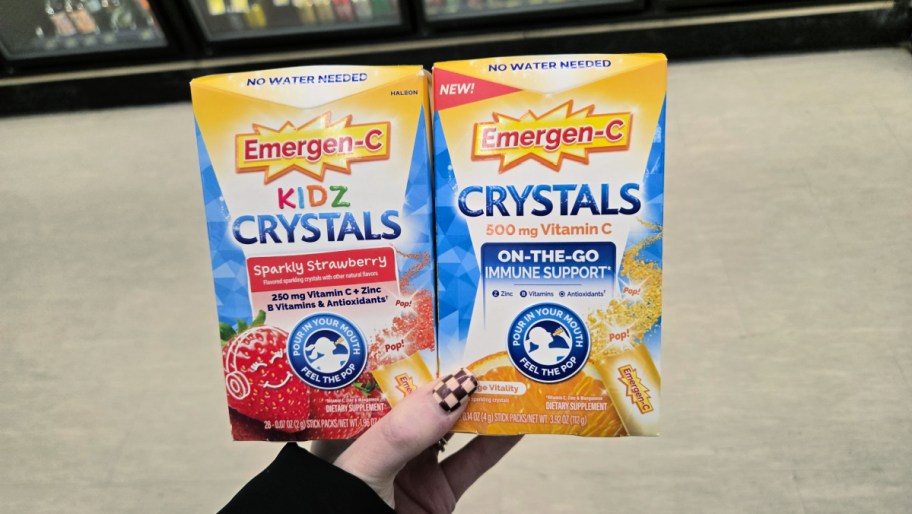 hand holding boxes of emergen c kids and adults crystals