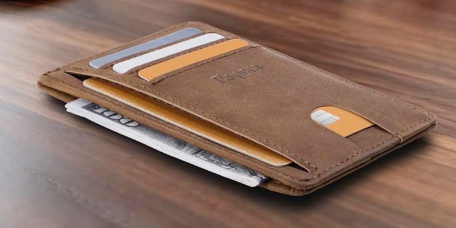 slim brown wallet on table