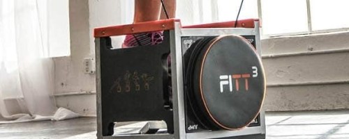 A person using a FITT Cube exercise device in a bright room.
