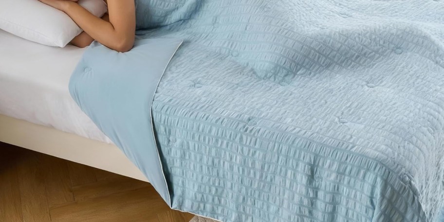blue comforter on bed 