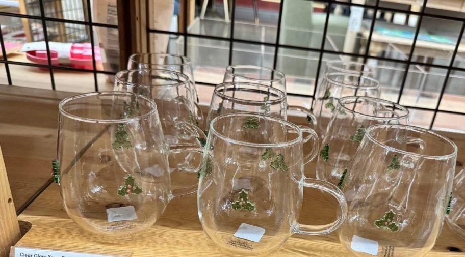 glass holly mugs on store shelf