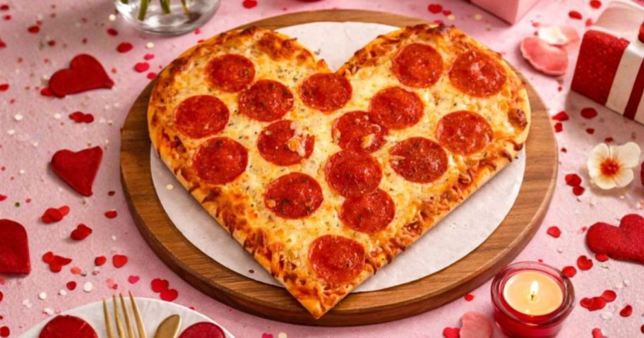 Connie's Heart-Shaped Pepperoni Pizza on table with decorations around it