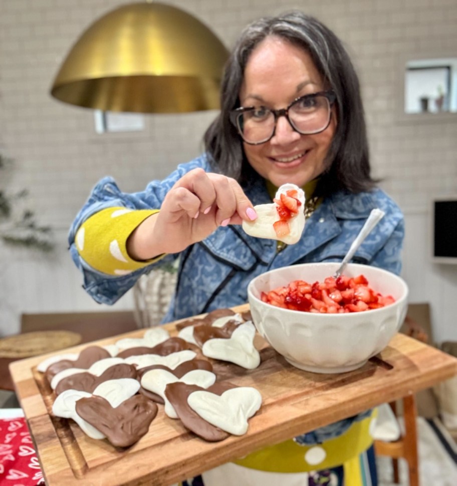 holding a tray of strawberry chips and salsa