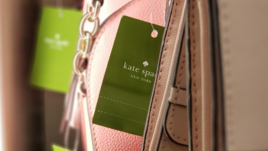 a kate spade tag hanging on a hand bag
