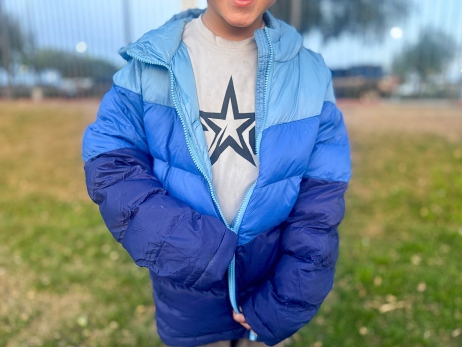 little boy in a blue hooded puffer jacket