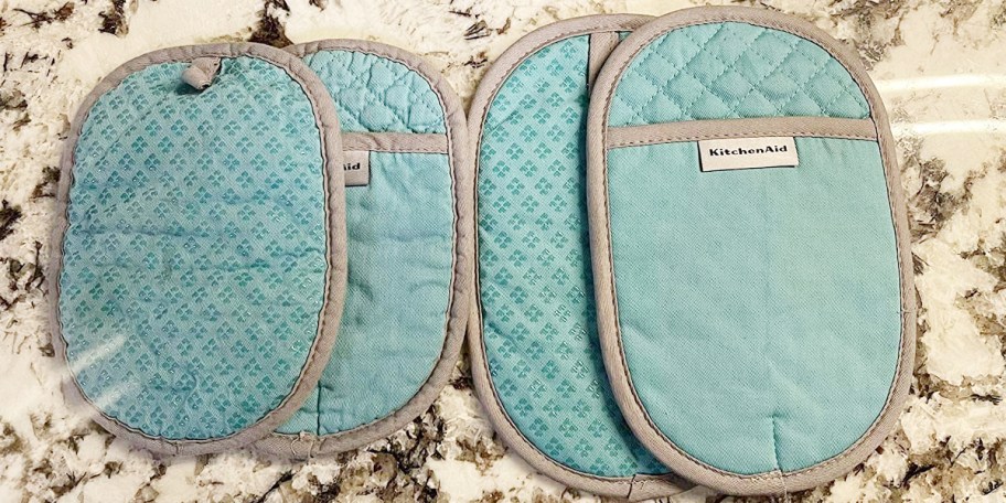 teal oven mitts on counter