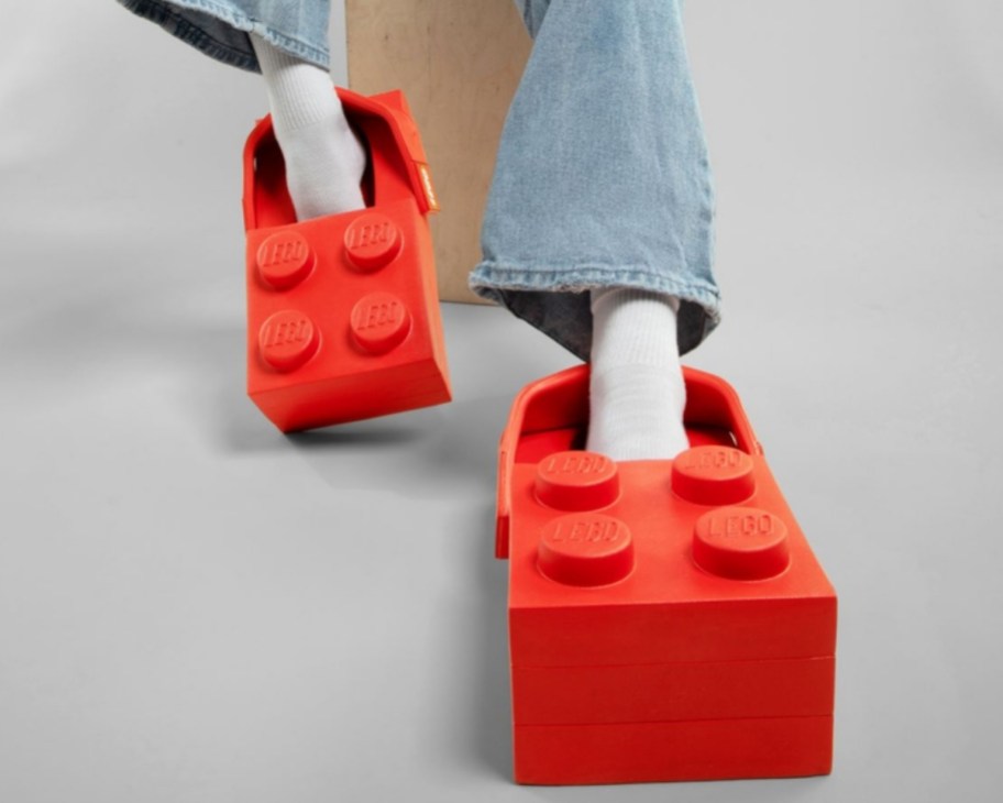 womans feet wearing lego brick clogs