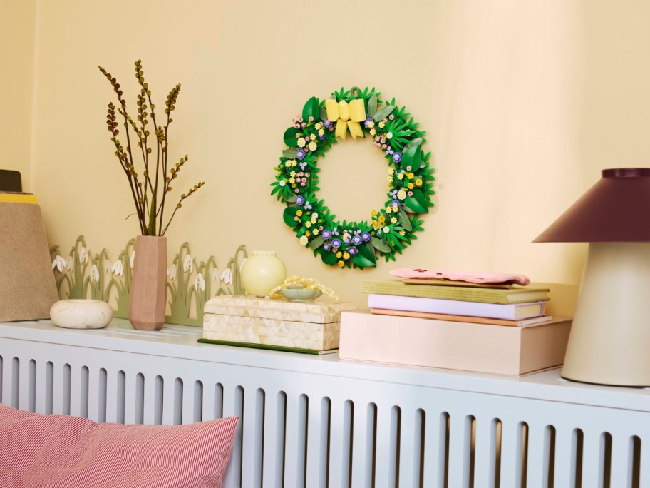 A complete Spring Wreath LEGO set hanging on a wall.