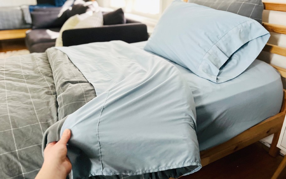 blue sheet set on twin bed 