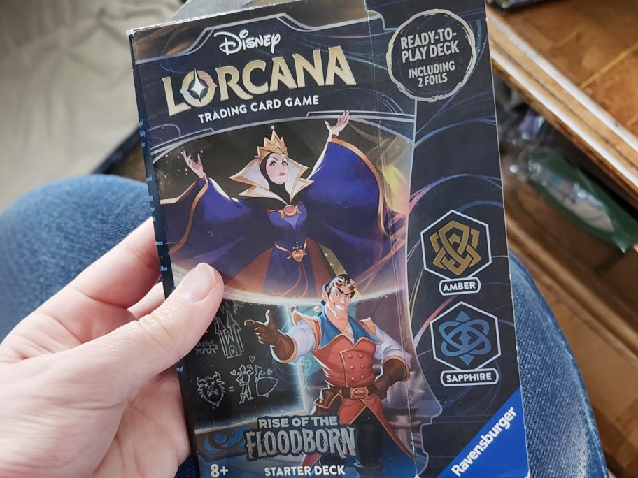 hand holding lorcana starter deck 