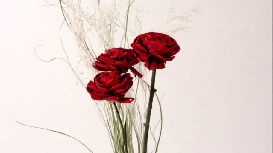 three red wooden roses