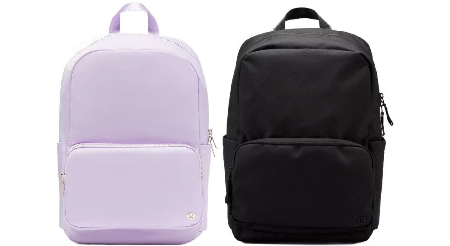 Two backpacks side by side: one pastel lavender with a front pocket, the other solid black. Both have zippers and top handles, conveying practicality.