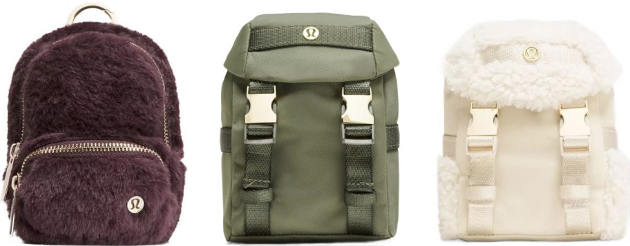 A lineup of three small backpacks: a plush burgundy bag with a front zipper, a green canvas bag with buckles, and a creamy sherpa bag with white straps.