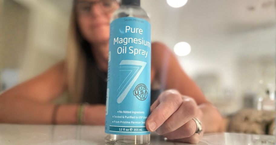 Bryn holding Seven Minerals Magnesium Spray bottle