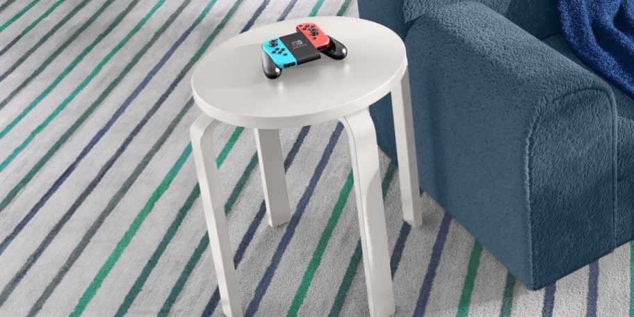 white nightstand with game controller on top
