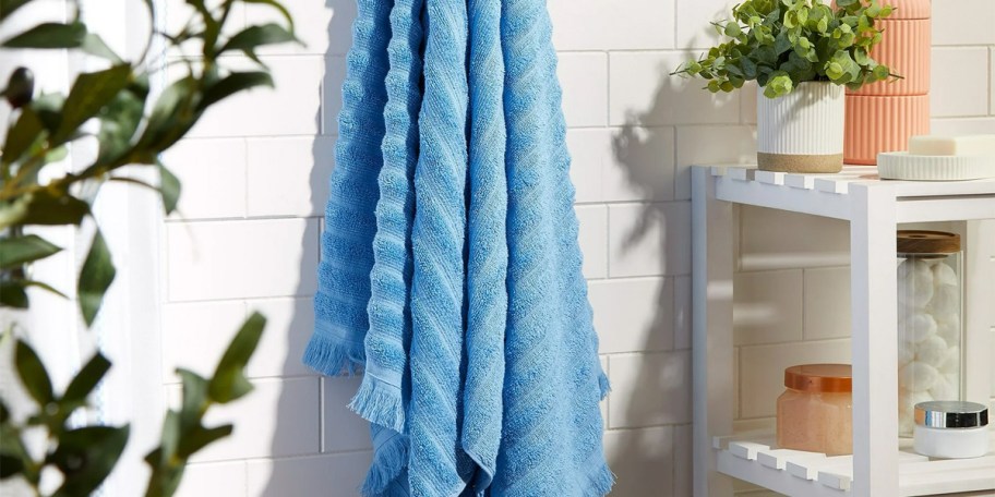blue towel hanging on wall 