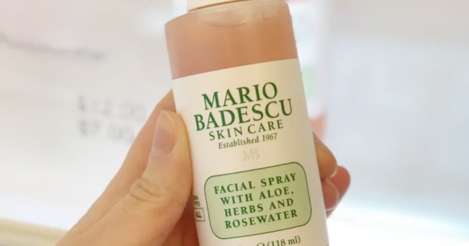 hand holding bottle of mario badescu spray