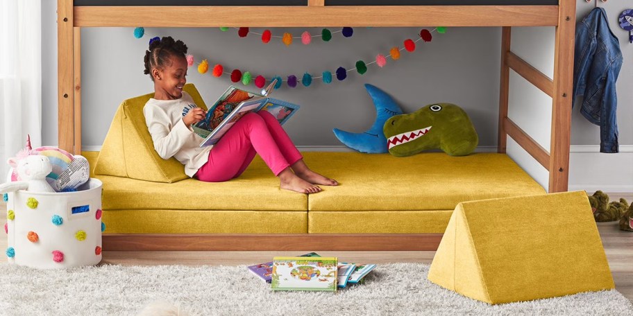 girl laying on yellow explorer sofa 