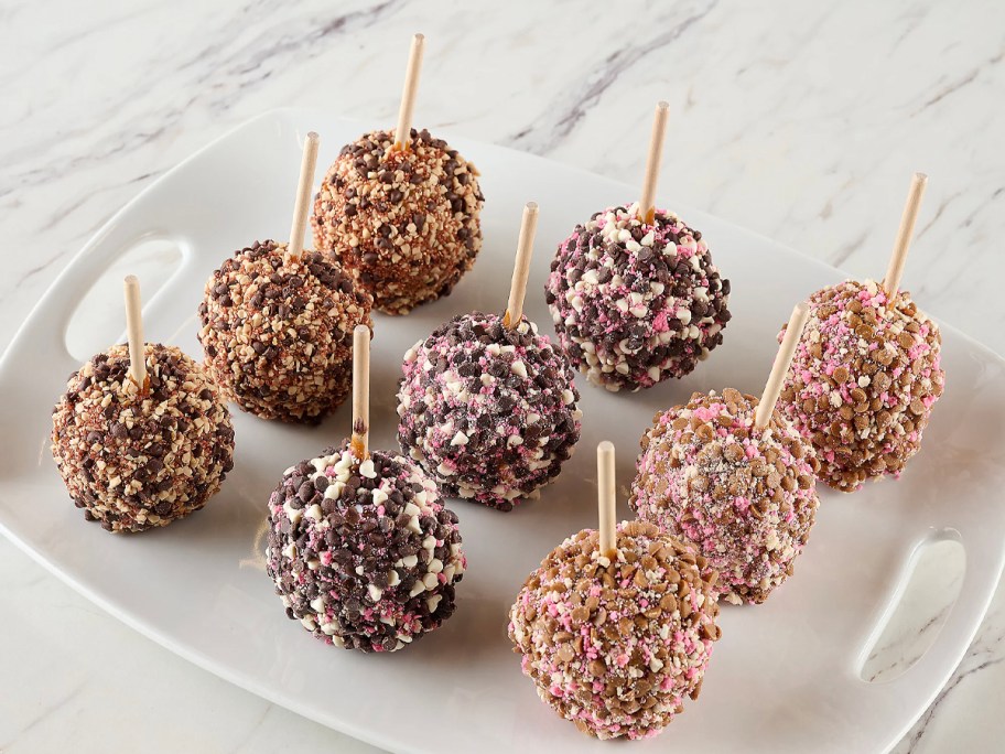 9 valentines day caramel apples on white plate 