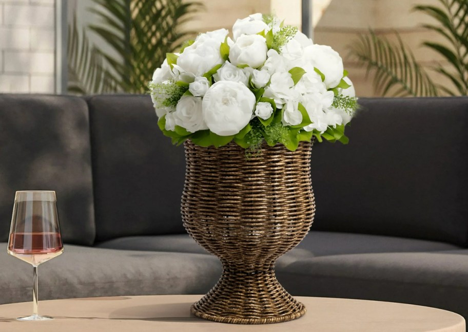 brown basket weave vase with white flowers