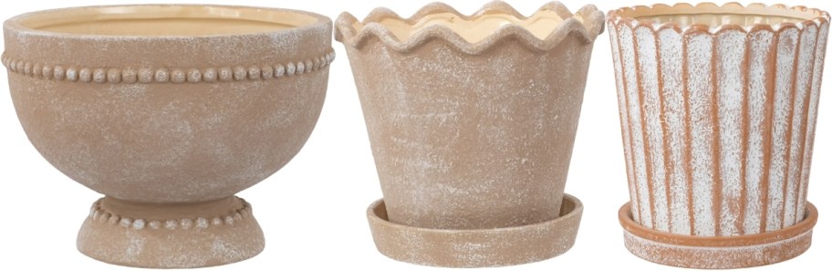 three terracotta look planters