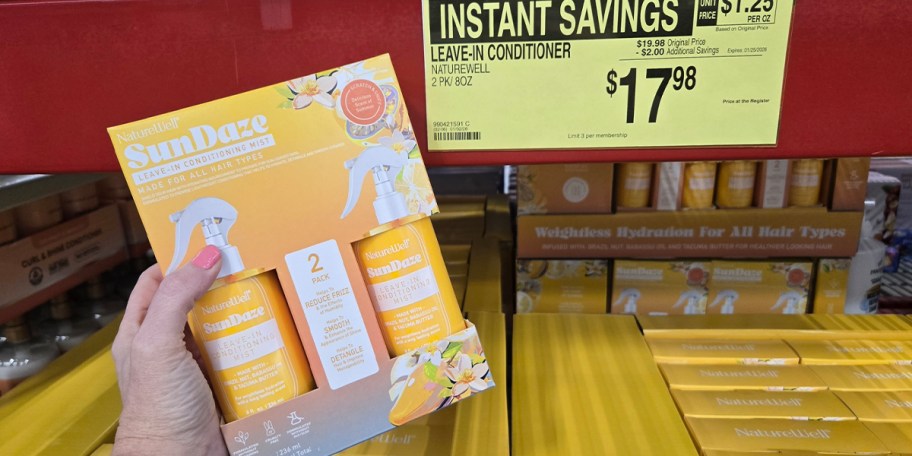 hand holding box of naturewell conditioner bottles 